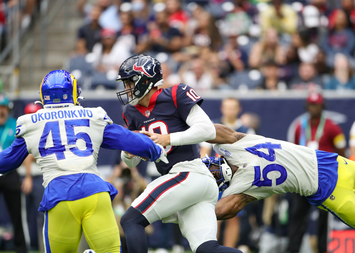 Los Angeles Rams linebacker Ogbonnia Okoronkwo (45) and linebacker Leonard Floyd (54) team up on a sack of Houston Texans quarterback Davis Mills (10) during an NFL game between Houston and the Los Angeles Rams on October 31, 2021 in Houston, Texas.