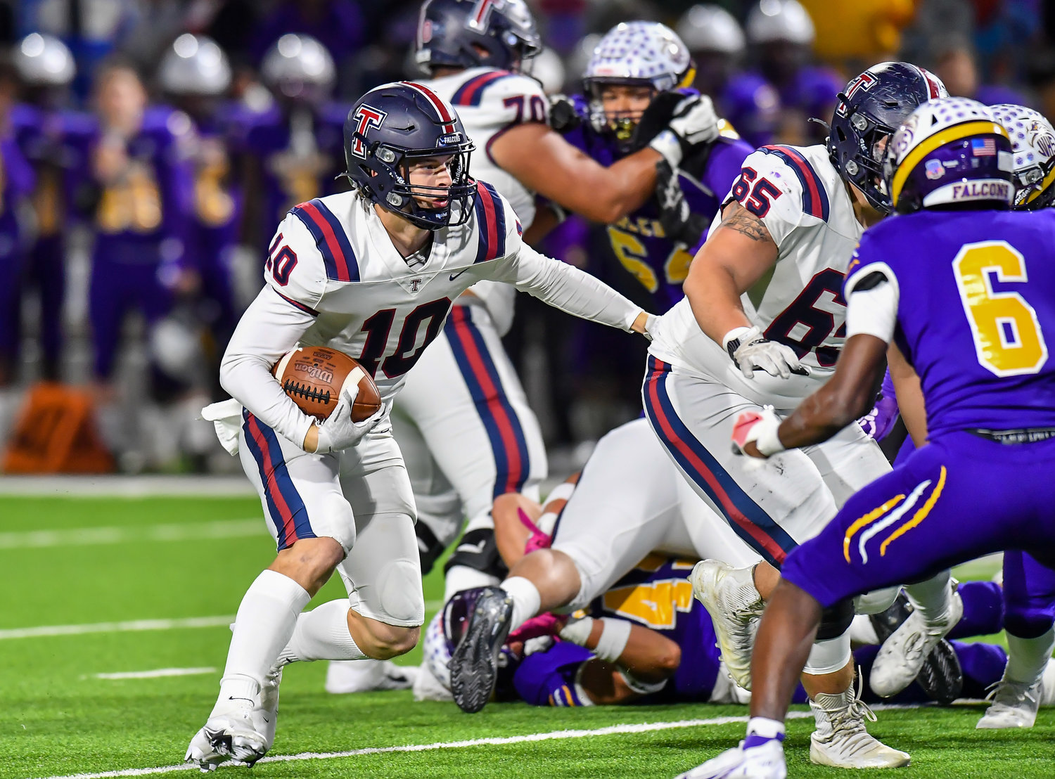 Houston Tx. Nov 19, 2021: Tompkins #10 Wyatt Young gets some blocking help from team mate #65 Ethan Vazquez was he carries the ball during the UIL area playoff game between Tompkins and Jersey Village at Pridgeon Stadium in Houston. (Photo by Mark Goodman / Katy Times)
