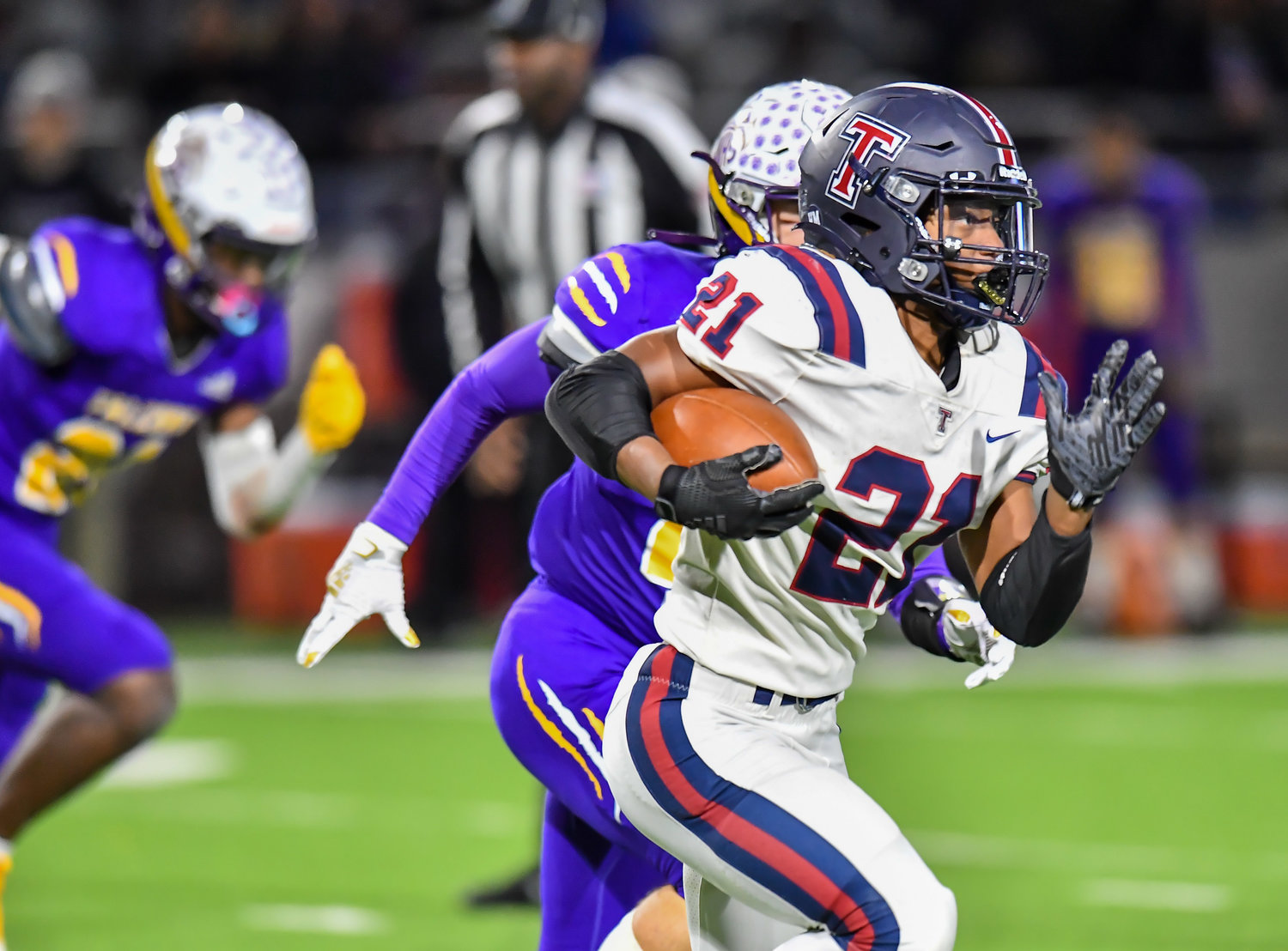 Houston Tx. Nov 19, 2021:  Tompkins #21 Caleb Blocker rushes to the outside for a first down during the UIL area playoff game between Tompkins and Jersey Village at Pridgeon Stadium in Houston. (Photo by Mark Goodman / Katy Times)