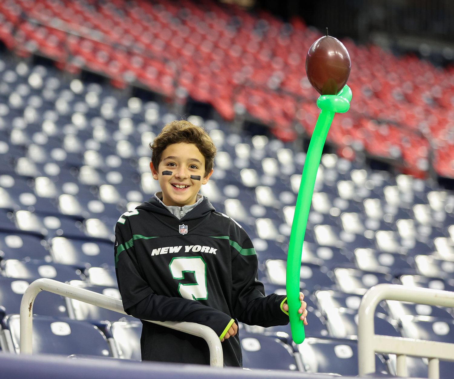A young New York Jets fan arrives early for an NFL game between the Houston Texans and the New York Jets on November 28, 2021 in Houston, Texas.