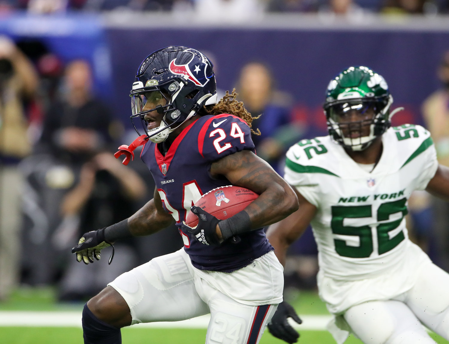 Houston Texans cornerback Tremon Smith (24) carries the ball on a kickoff return during an NFL game between the Houston Texans and the New York Jets on November 28, 2021 in Houston, Texas. The Jets won, 21-14