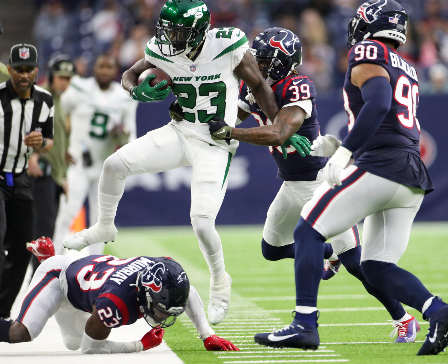 New York Jets running back Tevin Coleman (23) is run out of bounds by Houston Texans cornerback Terrance Mitchell (39) during an NFL game between the Houston Texans and the New York Jets on November 28, 2021 in Houston, Texas. The Jets won, 21-14