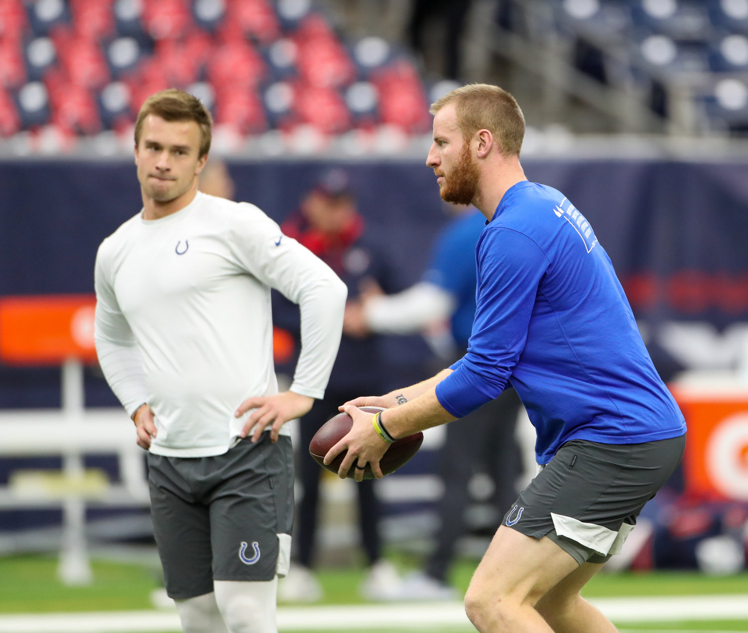 Indianapolis Colts and former Texas Longhorn and Westlake Chaparral quarterback Sam Ehlinger (4) watches as quarterback Carson Wentz (2) warms up before an NFL game between the Texans and the Colts on December 5, 2021 in Houston, Texas.