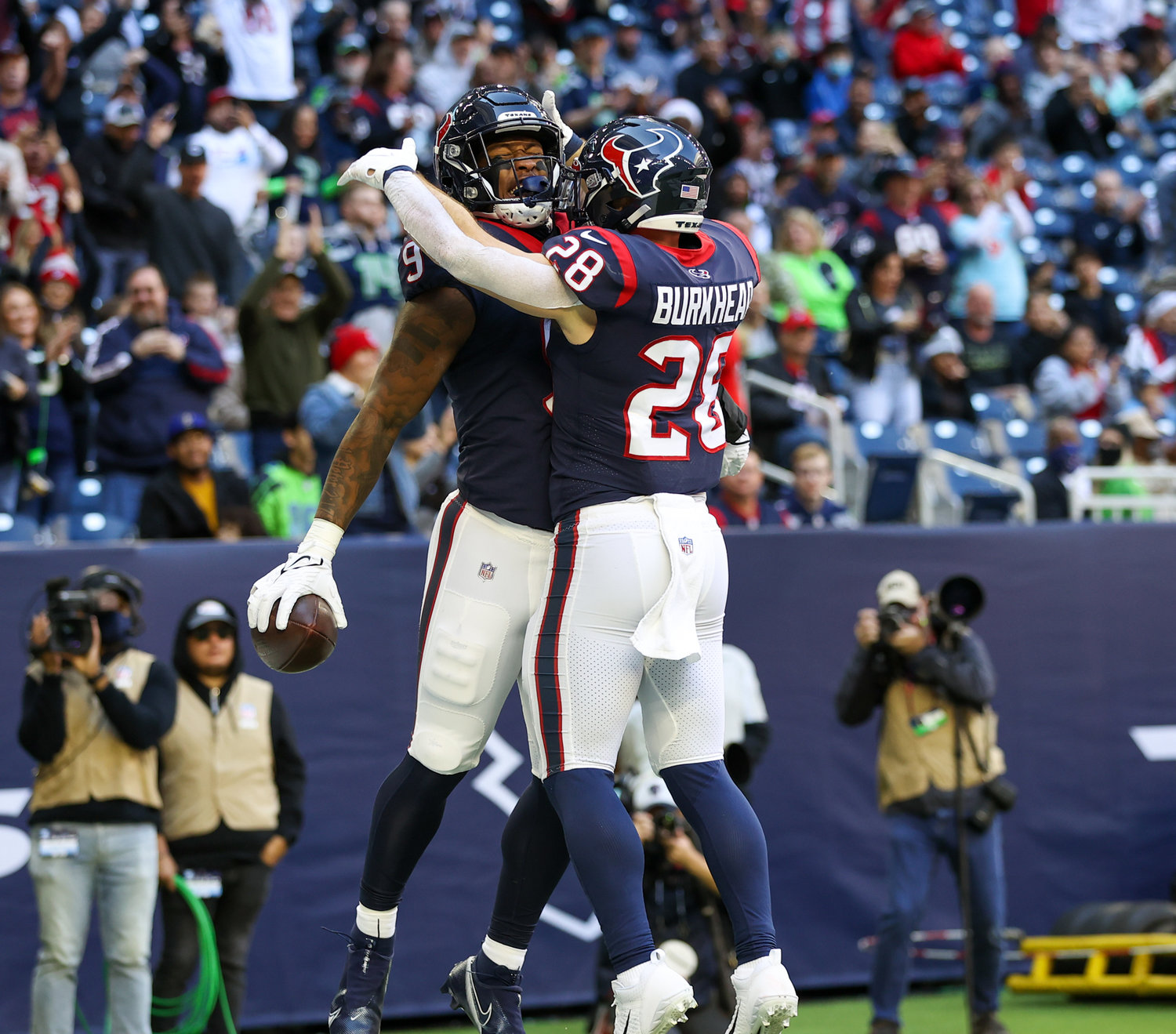 Houston Texans running back Rex Burkhead (28) congratulates tight end Brevin Jordan (9) after a touchdown during the first half of an NFL game between the Seahawks and the Texans on December 12, 2021 in Houston, Texas.