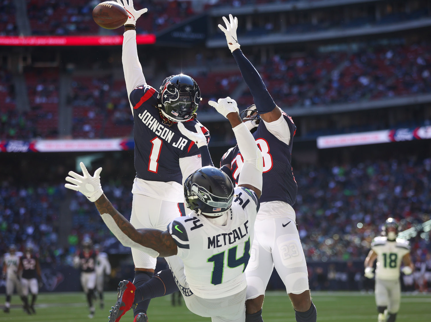 Houston Texans cornerback Lonnie Johnson Jr. (1) knocks down a pass intended for Seattle Seahawks wide receiver DK Metcalf (14) in the end zone during the second half of an NFL game between the Seahawks and the Texans on December 12, 2021 in Houston, Texas.