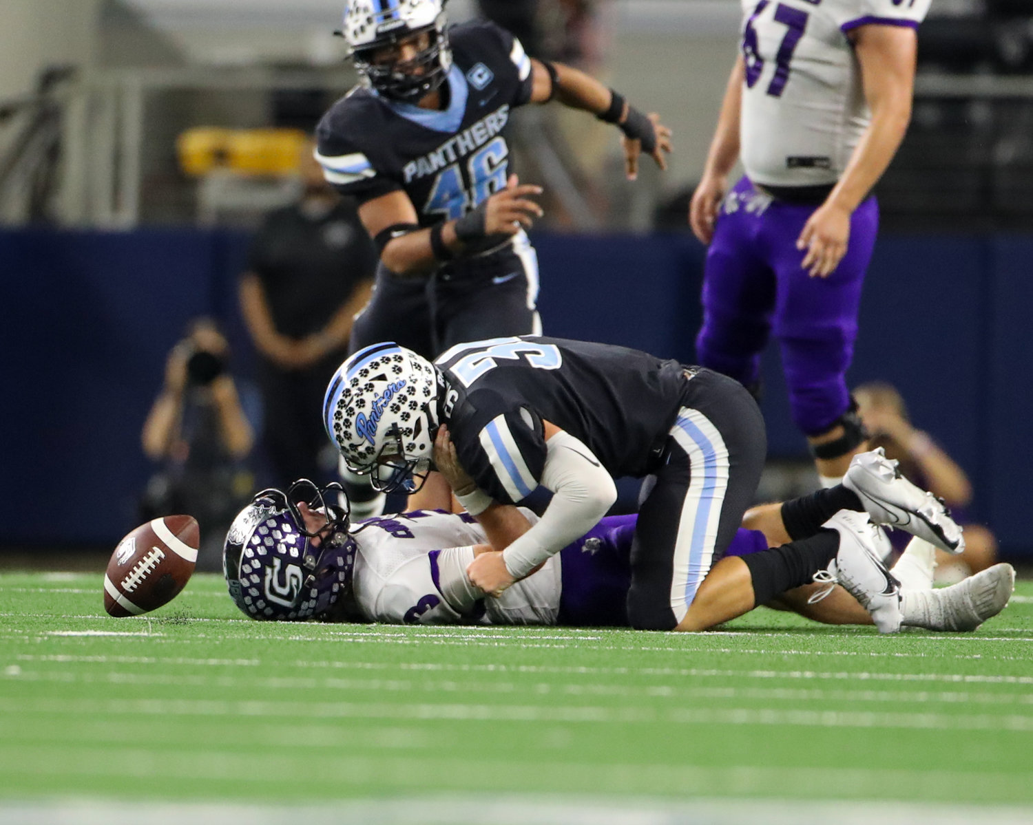 The ball comes loose as Paetow Panthers linebacker Tyler Silves (34) sacks College Station Cougars quarterback Jett Huff (3) during the Class 5A Division I state football championship game between Paetow and College Station on December 17, 2021 in Arlington, Texas.