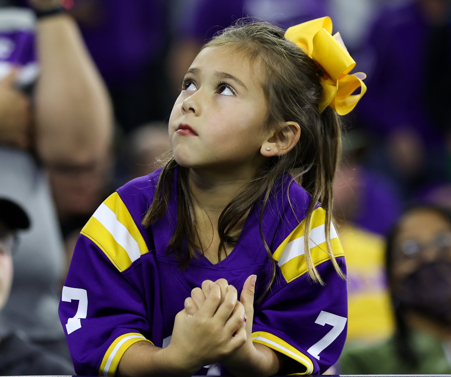 A.young LSU Tigers fan looks up at the scoreboard as Kansas State takes a 14-0 lead in the TaxAct Texas Bowl on Jan. 4, 2022 in Houston, Texas.