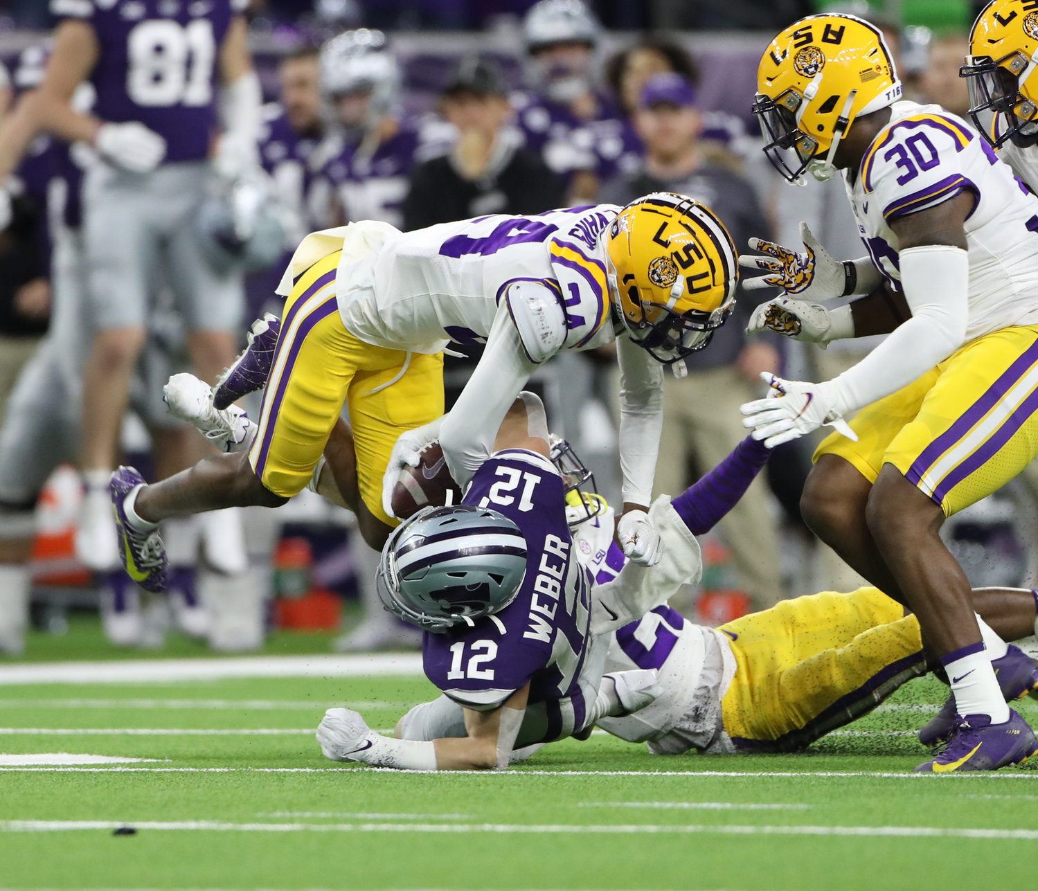 LSU Tigers cornerback Darren Evans (24) dives in as Kansas State Wildcats wide receiver Landry Weber (12) is tackled during the TaxAct Texas Bowl on Jan. 4, 2022 in Houston, Texas.