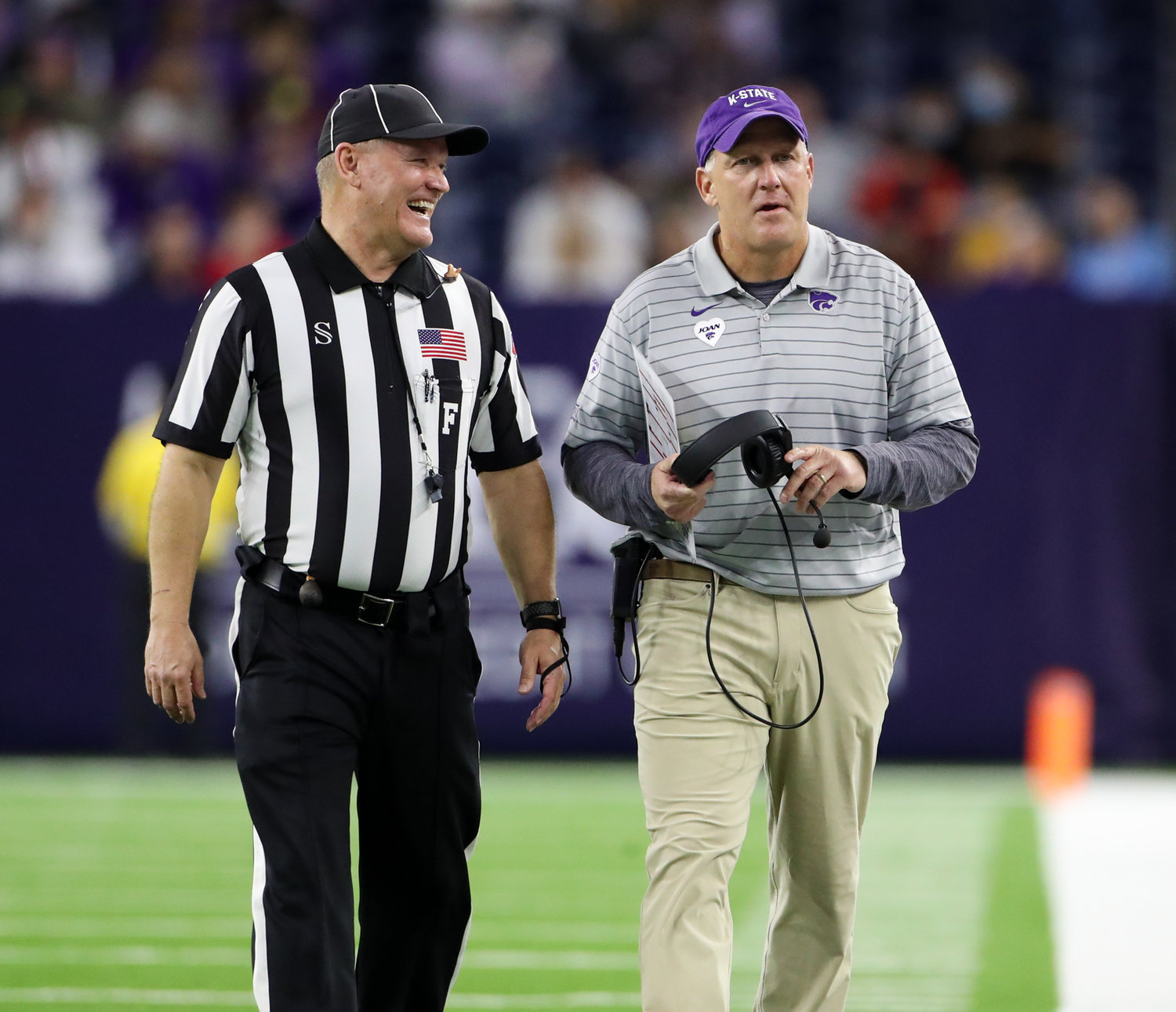 Field judge Timothy Maguire has a laugh with Kansas State Wildcats head coach Chris Klieman during the TaxAct Texas Bowl on Jan. 4, 2022 in Houston, Texas.