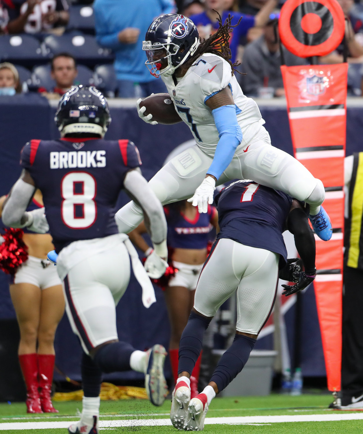 Tennessee Titans running back D'Onta Foreman (7) hurdles Houston Texans cornerback Lonnie Johnson Jr. (1) during an NFL game between the Texans and the Titans on Jan. 9, 2022 in Houston, Texas.