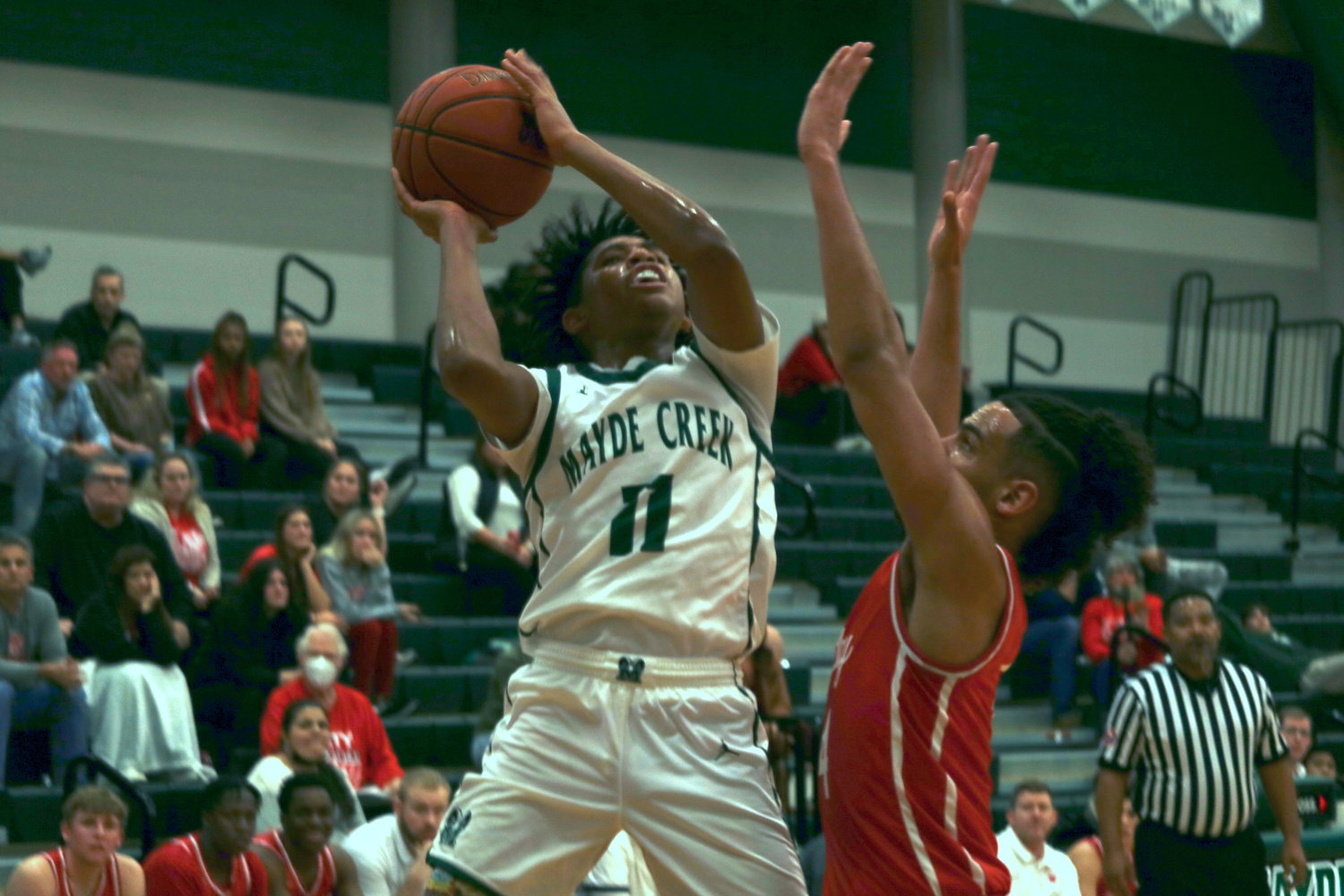 Mayde Creek’s Larison Lamette shoots over Katy’s Dayvaughn Froe during Wednesday’s game at the Mayde Creek gym.