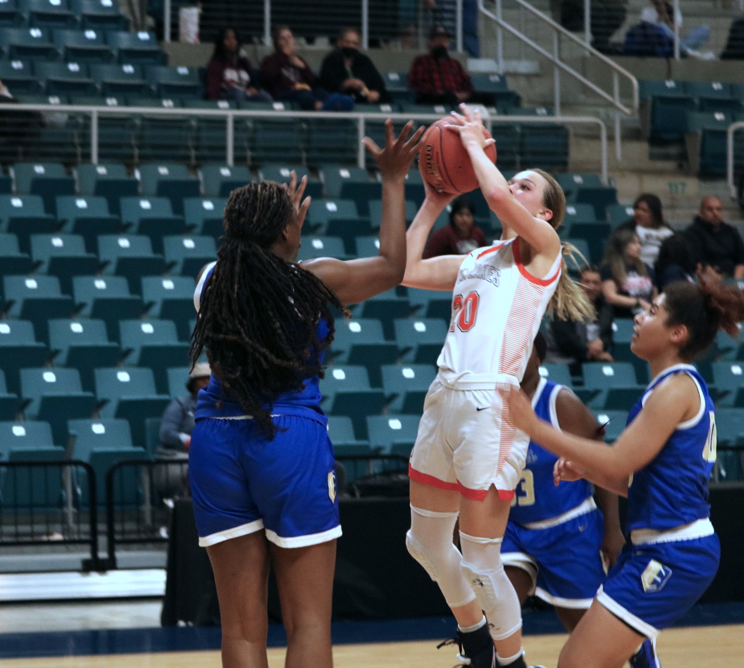 Seven Lakes Summer Halphen shoots over a defender Seven Lakes’ Justice Carlton drives to the basket during Tuesday’s Class 6A bi-district game against Fort Bend Elkins at the Merrell Center.
