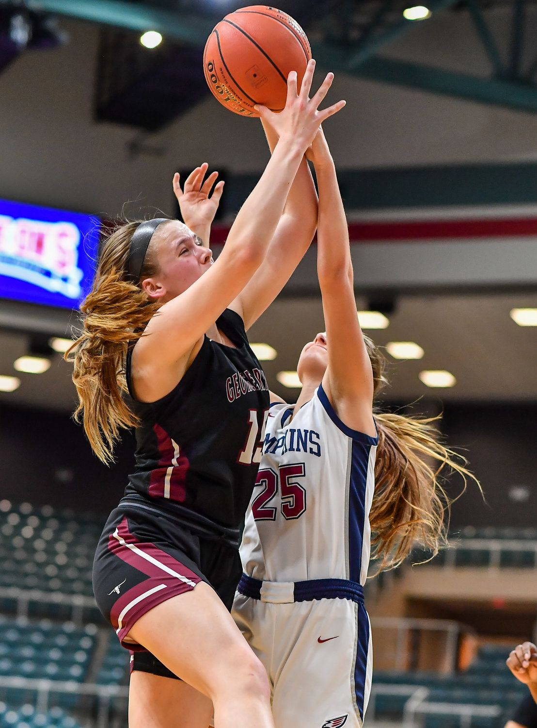 Katy Tx. Feb 15, 2022:  Tompkins Kennedy Bourque #25 and George Ranch's Lauren Stevens #15 battle for the rebound during the Bi-District playoff, Tompkins vs George Ranch. (Photo by Mark Goodman / Katy Times)