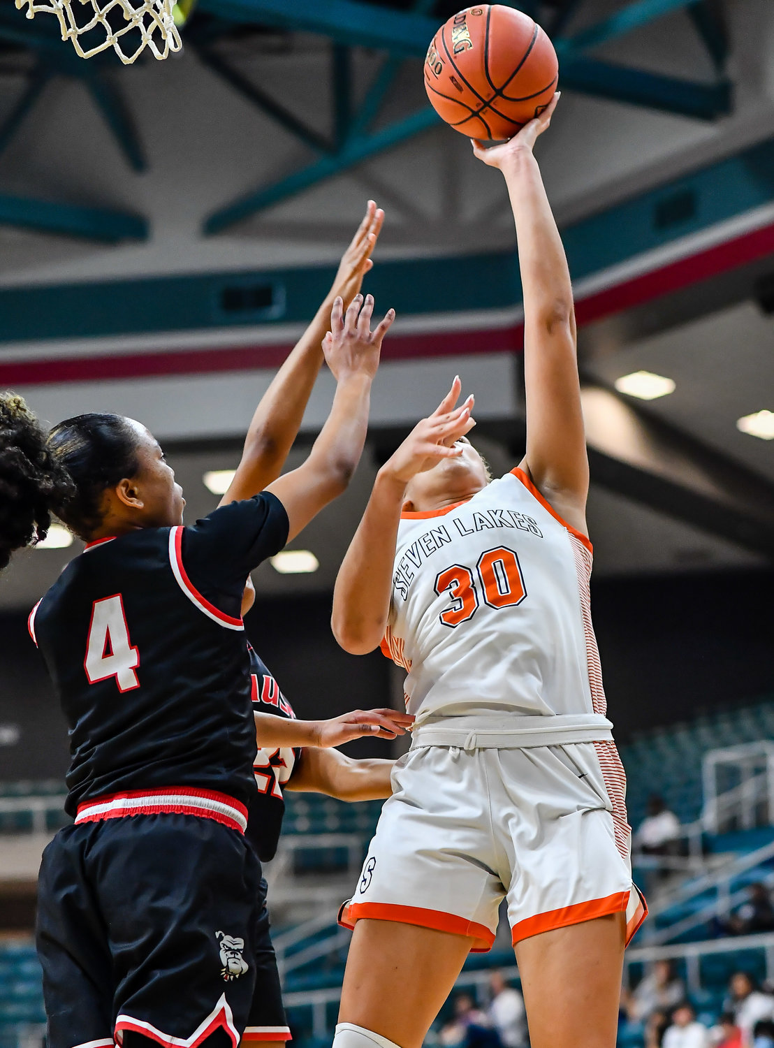 Katy Tx. Feb 22, 2022:  Seven Lakes Justice Carlton #30 scores under the basket during the Regional Quarterfinal playoff game, Seven Lakes vs Fort Bend Austin at the Merrell Center. (Photo by Mark Goodman / Katy Times)