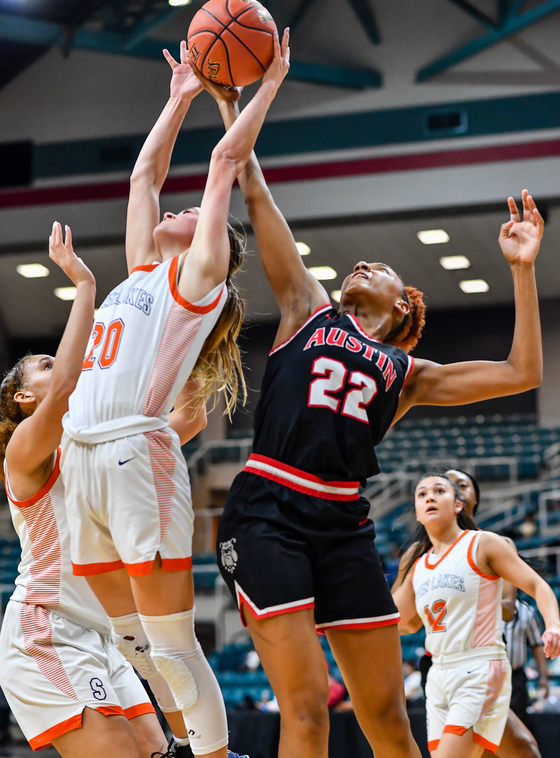 Katy Tx. Feb 22, 2022: Seven Lakes Summer Halphen #20 and Fort Bend Austins Gabrielle Johnson #22 battle for the rebound during the Regional Quarterfinal playoff game, Seven Lakes vs Fort Bend Austin at the Merrell Center. (Photo by Mark Goodman / Katy Times)