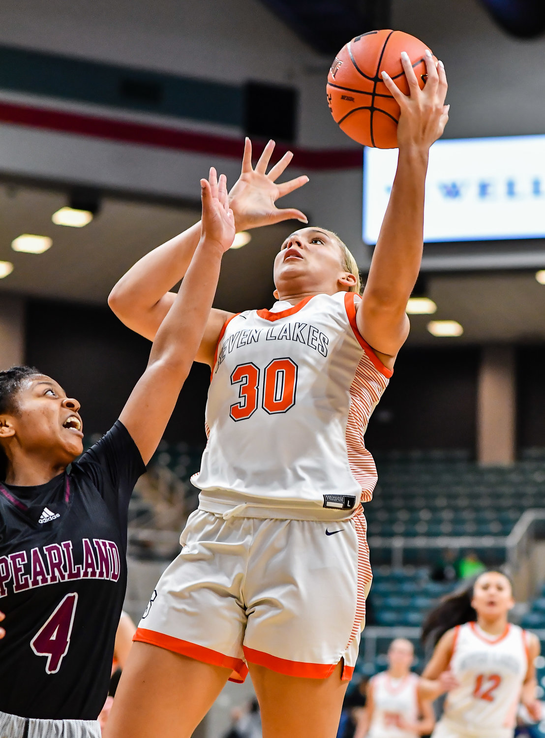 Katy Tx. Feb 25, 2022:  Seven Lakes Justice Carlton #30 drives to the basket guarded by Pearlands Paige Bonner #4 during the Regional SemiFinal playoff game, Seven Lakes vs Pearland at the Merrell Center. (Photo by Mark Goodman / Katy Times)