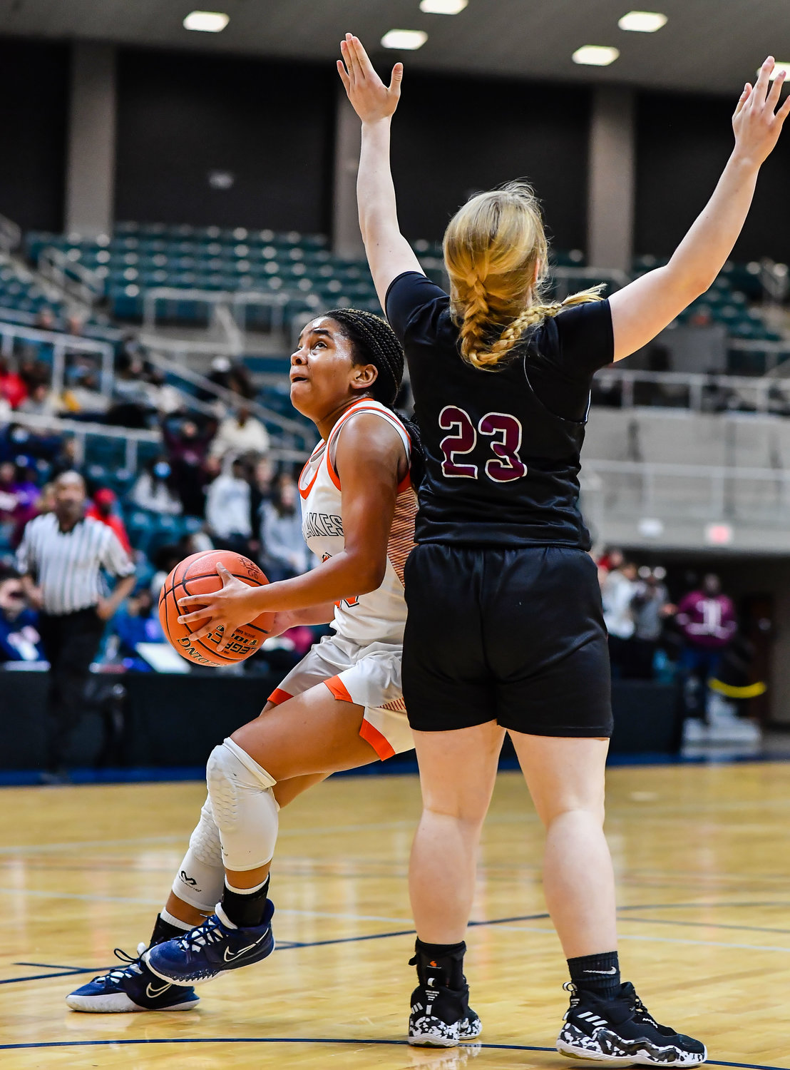 Katy Tx. Feb 25, 2022:  Seven Lakes Lenore Hudspeth #23 drives around Pearlands Lauren Smith #23 to the basket during the Regional SemiFinal playoff game, Seven Lakes vs Pearland at the Merrell Center. (Photo by Mark Goodman / Katy Times)