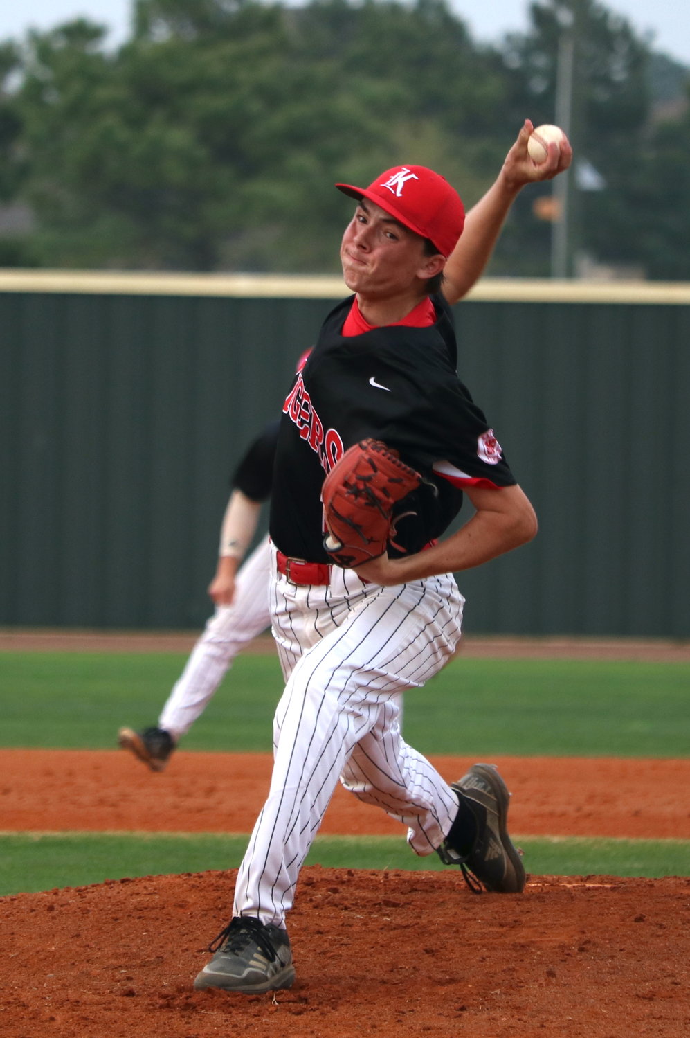 Lucas Moore pitches during Tuesday’s District 19-6A game between Katy and Tompkins at the Tompkins baseball field.
