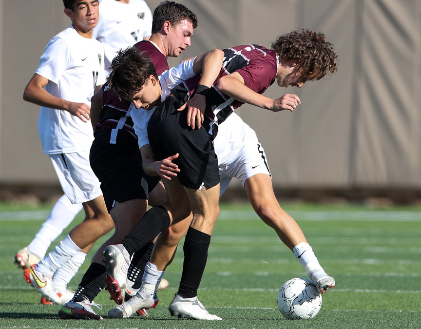 Jordan midfielder Marcelo Ojeda (8) works against Dripping Springs forward Brenden Gajewski (20) and midfielder Mason Russell (5) during the Class 5A boys state semifinal on April 14, 2022 in Georgetown, Texas.
