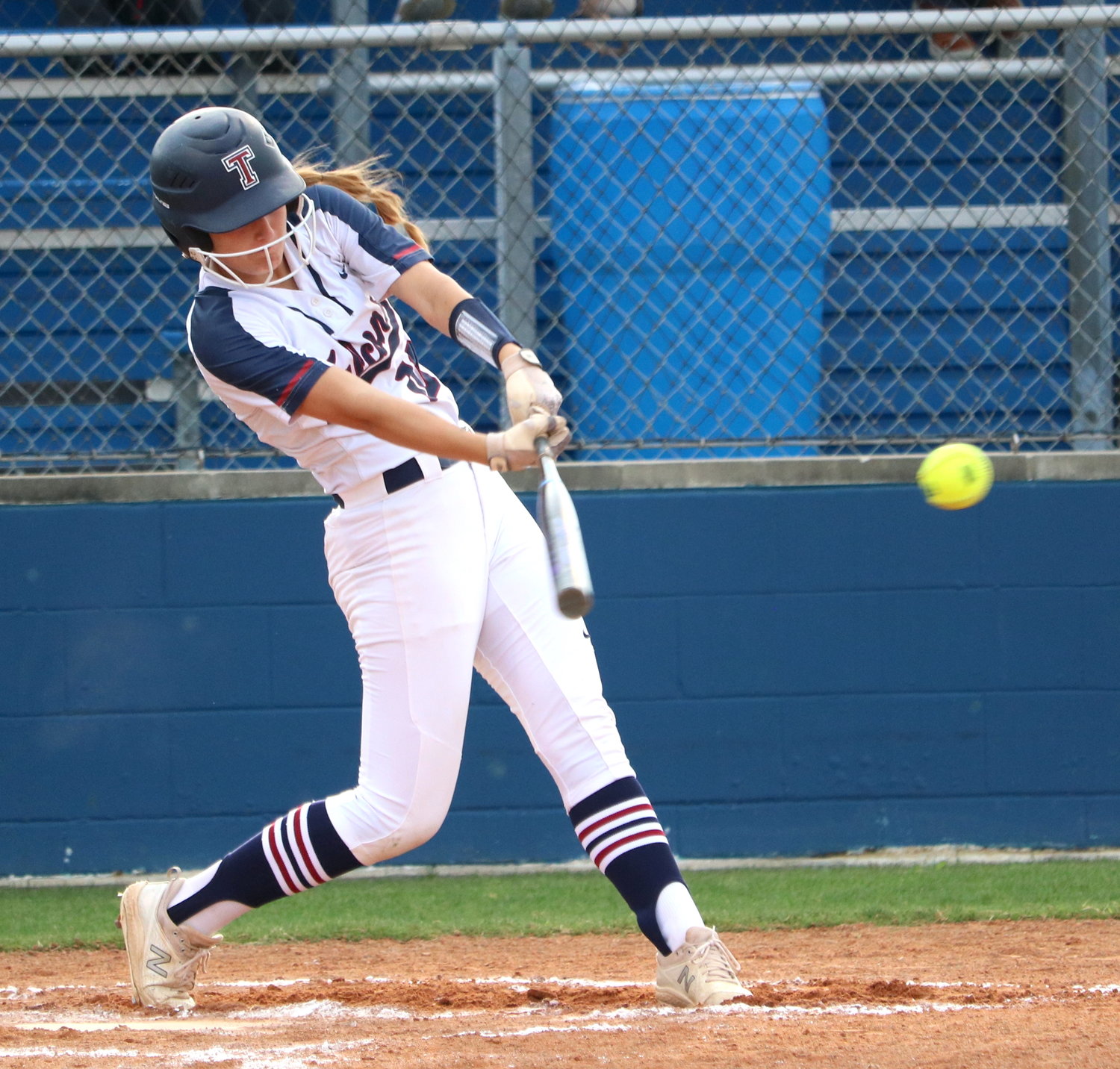 A Tompkins player hits during Thursday’s bi-district game between Tompkins and George Ranch at the Tompkins softball field.