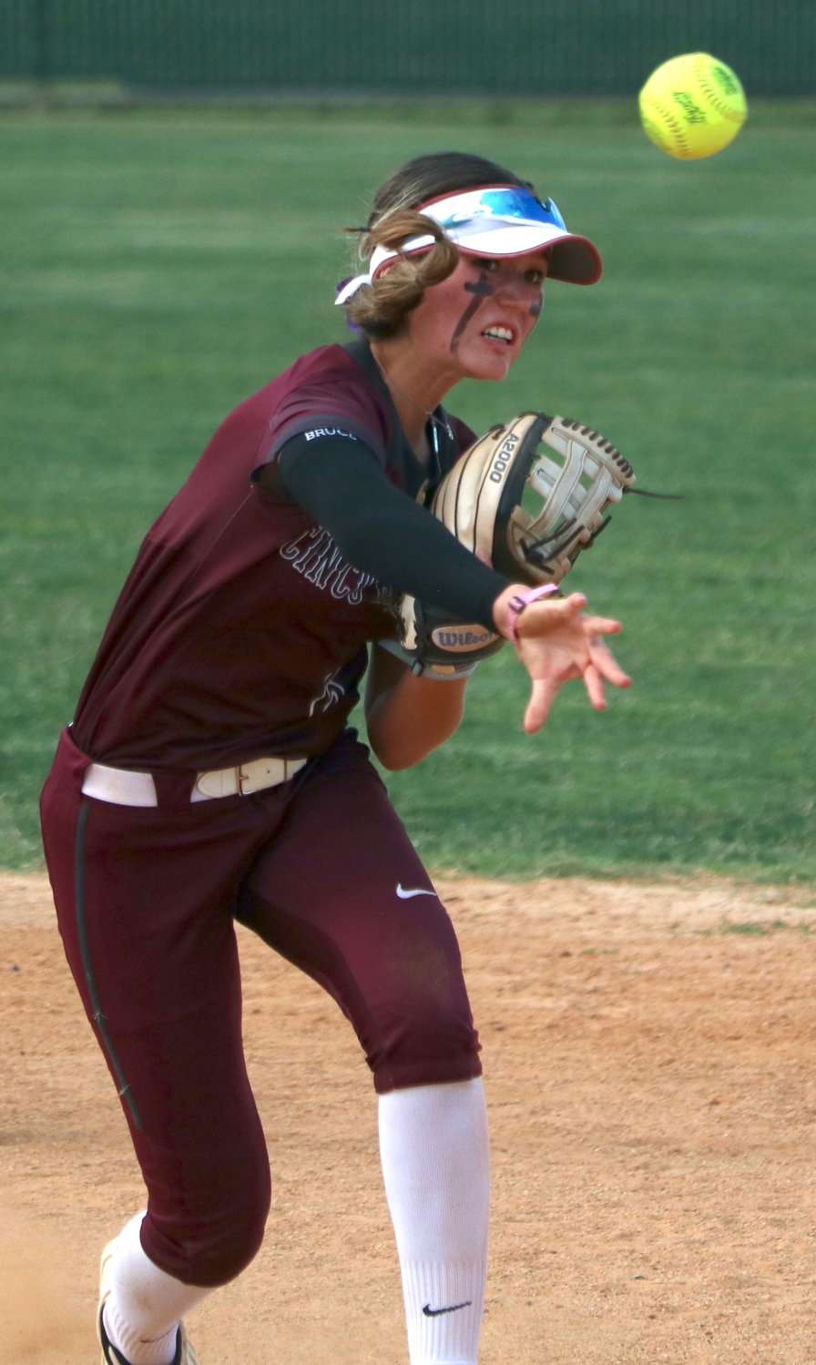 Faith Piper throws to first base during Friday’s bi-district game between Cinco Ranch and Fort Bend Travis.