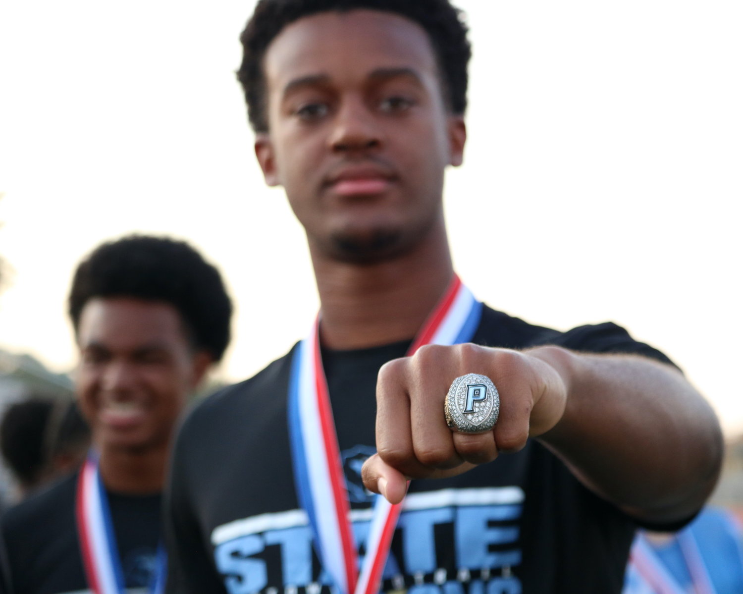 CJ Dumas shows off his state championship ring during Thursday’s ring ceremony at Paetow.