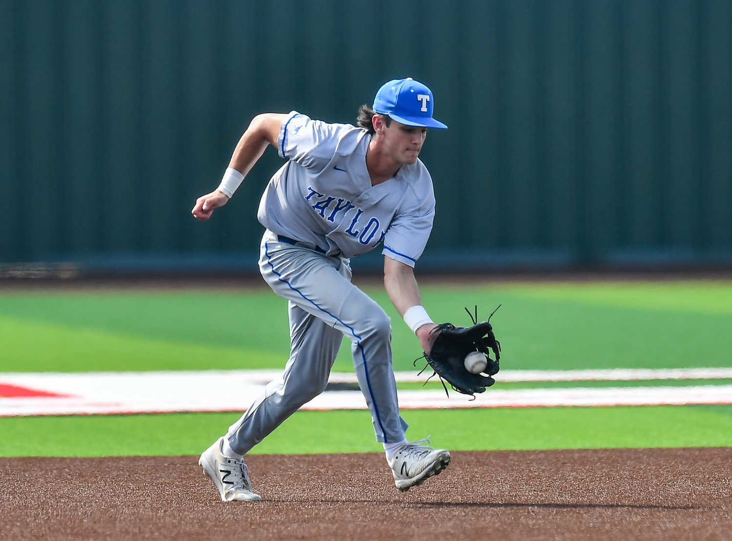 Katy Taylor's Camden Champness (4) fields a ground ball during the second inning in a Region III-6A quarterfinals baseball game at Langham Creek High School, Saturday, May 21, 2022.