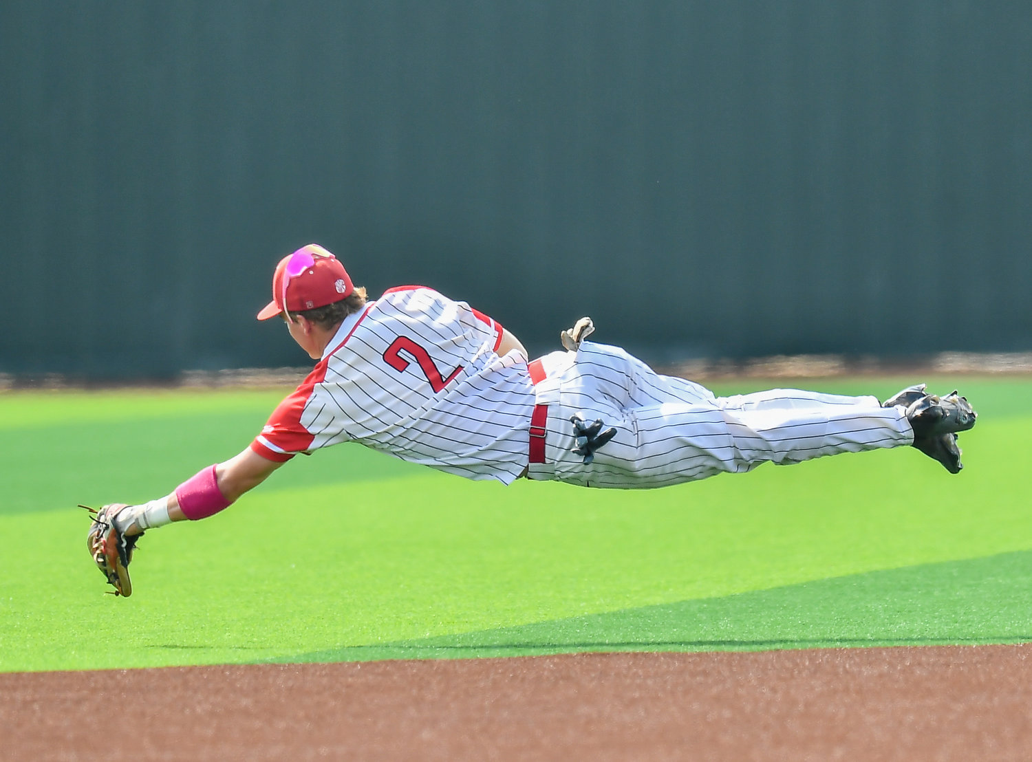 Katy's Parker Kidwell (2) dives for the ball during the second inning in a Region III-6A quarterfinals baseball game at Langham Creek High School, Saturday, May 21, 2022.