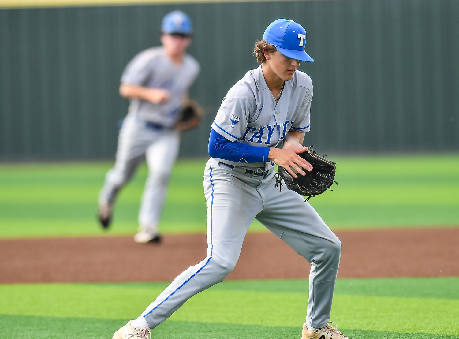Katy Taylor's Jared Schaeffer (12) fields a ball hit back to the mound during the third inning during a Region III-6A quarterfinals baseball game at Langham Creek High School, Saturday, May 21, 2022.
