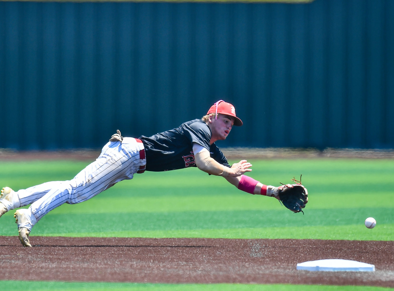 Katy's Parker Kidwell (2) dives for the ball during the fourth inning of game three in a Region III-6A Regional SemiFinals baseball game between Katy and Strake Jesuit at Jersey Village High School, Saturday, May 28, 2022.