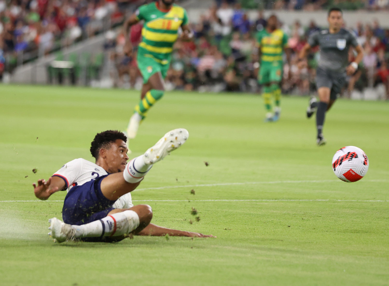 United States defender Reggie Cannon (22) makes a sliding shot during a Concacaf Nations League match on June 10, 2022 in Austin, Texas.