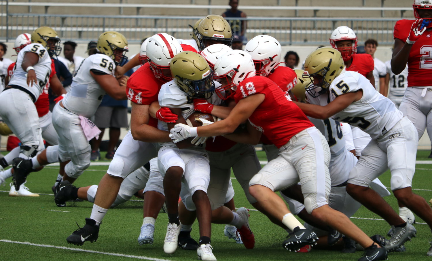 Katy’s defense makes a stop during Katy’s scrimmage against Klein Collins on Friday at Legacy Stadium.