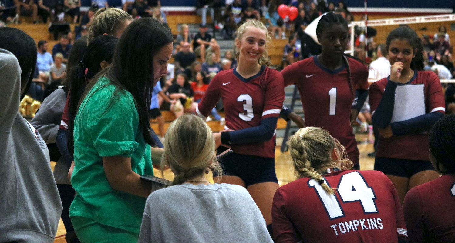 Tompkins players listen to head coach Allison Merrell during a timeout during Tuesday’s match between Tompkins and Katy at the Tompkins gym.