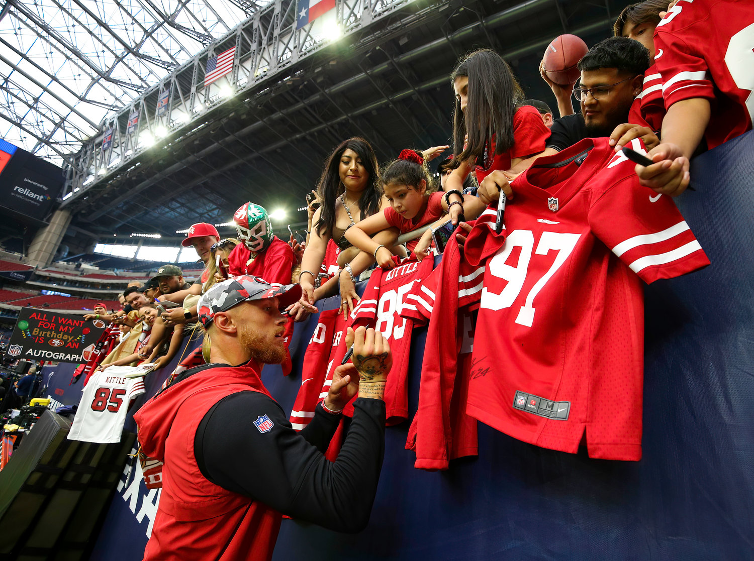 San Francisco 49ers tight end George Kittle (85) signs autographs before the start of an NFL preseason game between the Texans and the 49ers in Houston, Texas, on August 25, 2022.