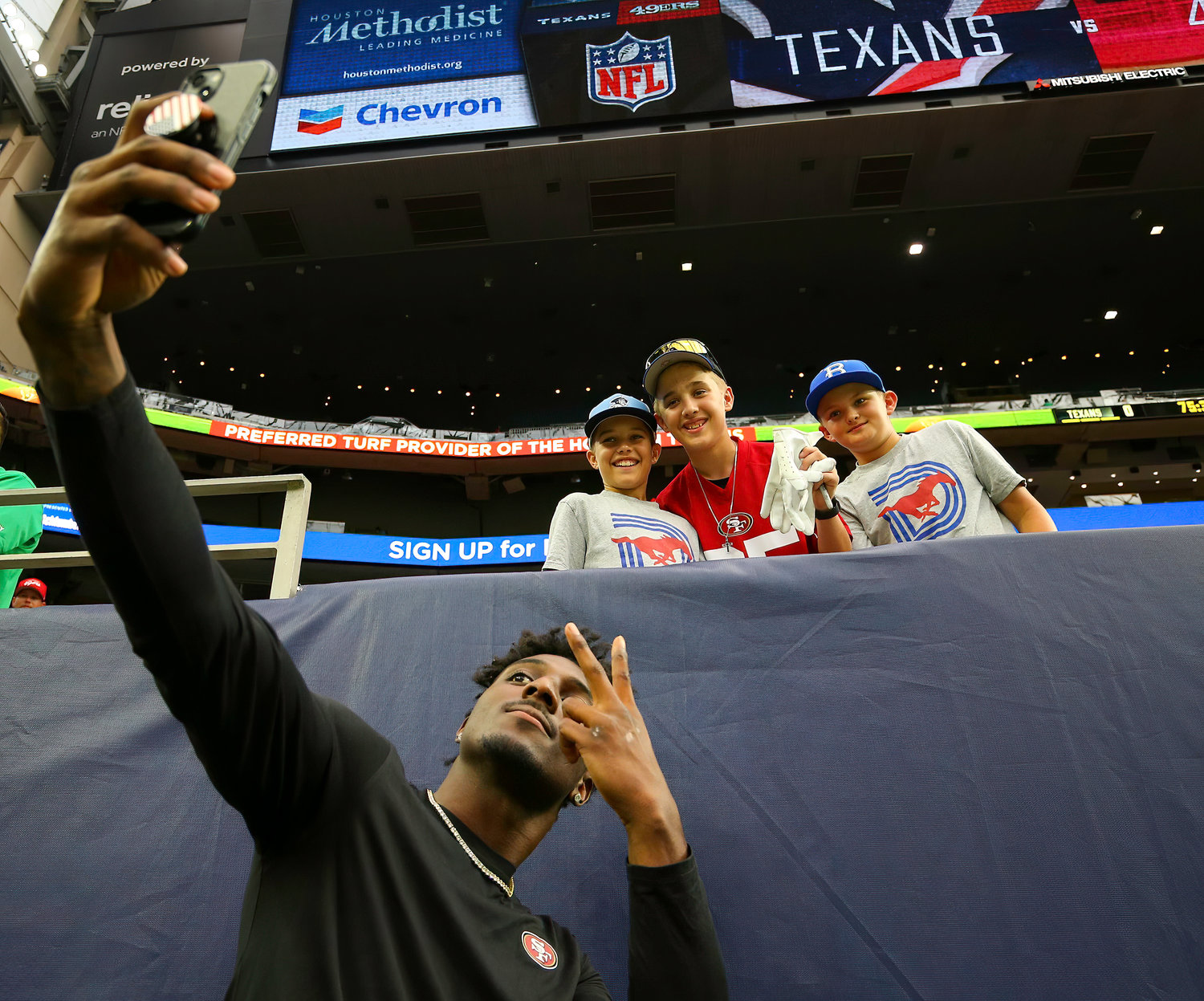San Francisco 49ers wide receiver Danny Gray (86) takes a photo with a group of young fans before the start of an NFL preseason game between the Texans and the 49ers in Houston, Texas, on August 25, 2022.
