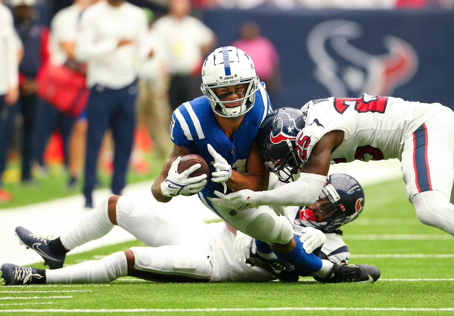 Houston Texans cornerbacks Steven Nelson (21) and  Desmond King II (25) tackle Indianapolis Colts wide receiver Michael Pittman Jr. (11) after a catch in an NFL game between the Texans and the Colts on September 11, 2022 in Houston. The game ended in a 20-20 tie after a scoreless overtime period.