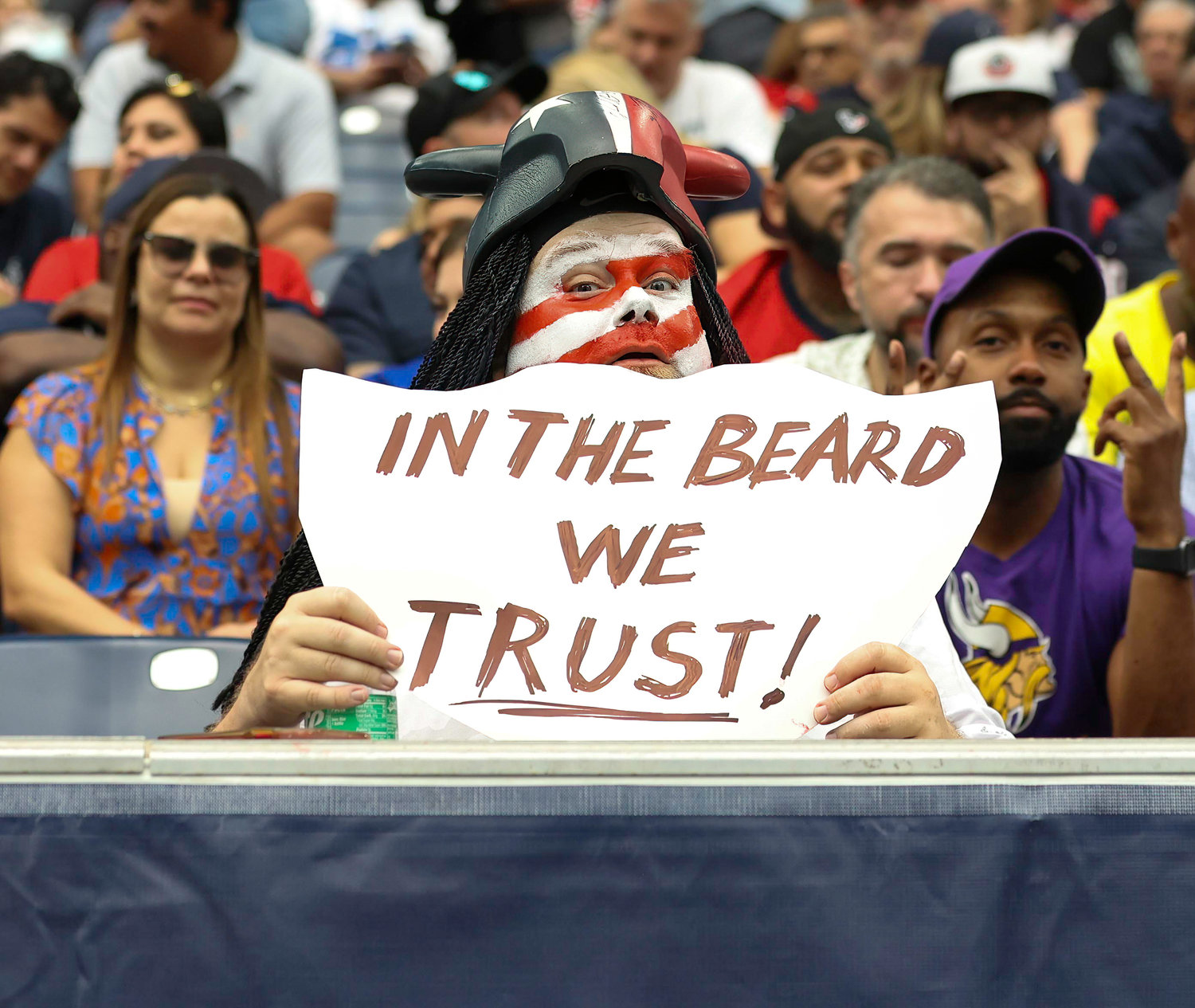 A Houston Texans fan holds a sign referencing head coach Lovie Smith, who is known for his beard, during an NFL game between the Texans and the Colts on September 11, 2022 in Houston. The game ended in a 20-20 tie after a scoreless overtime period.