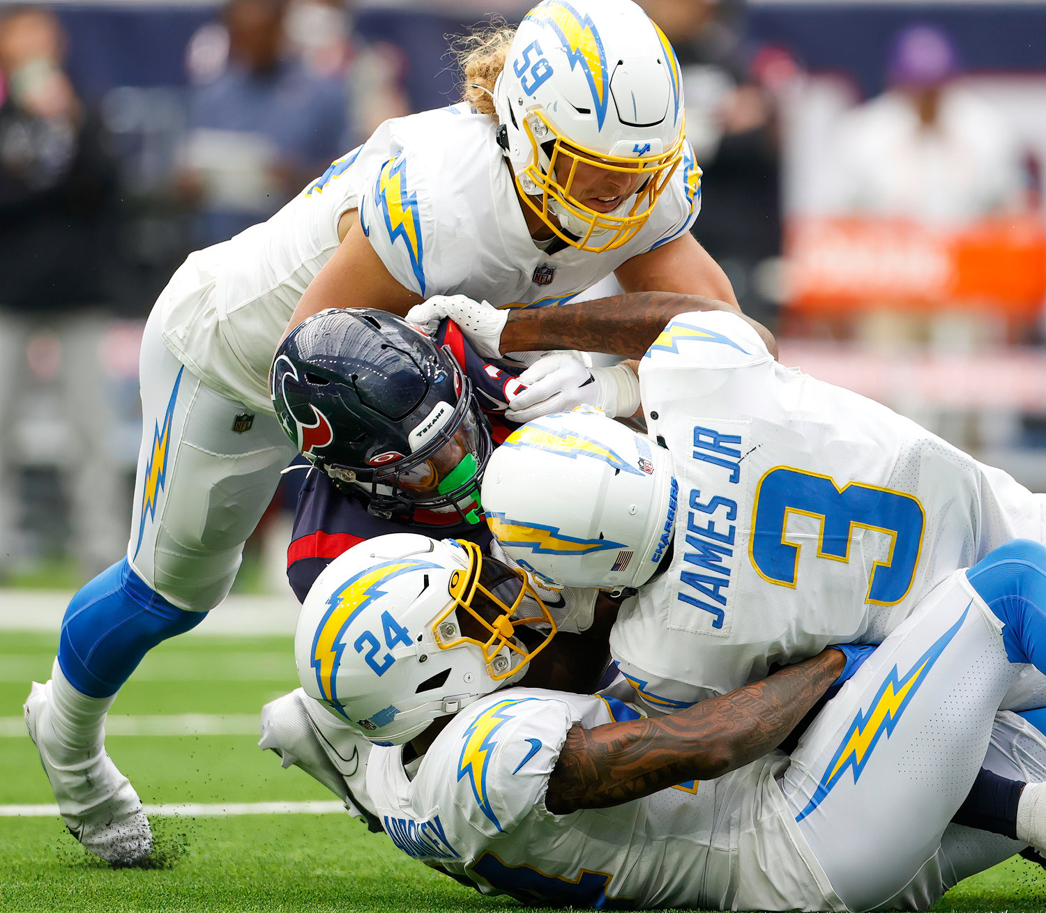 Texans running back Dameon Pierce (31) is wrapped up by a group of Chargers defenders during an NFL game between the Texans and the Chargers on Oct. 2, 2022 in Houston. The Chargers won 34-24.