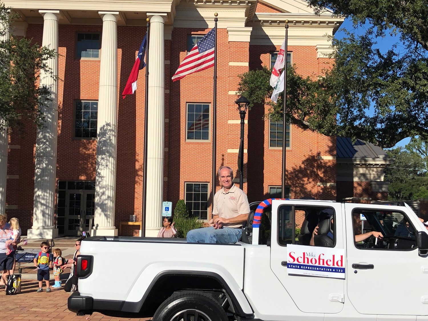 State Rep. Mike Schofield, whose Harris County district includes much of Katy, enjoys a ride past Katy City Hall.