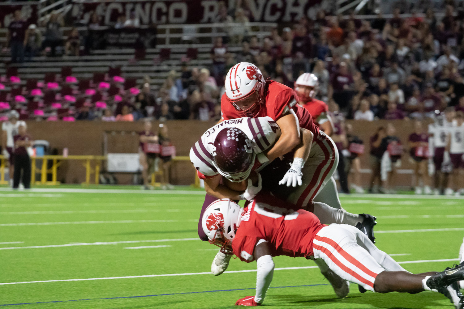 Katy players bring down a Cinco Ranch ballcarrier during Friday's game between Katy and Cinco Ranch at Rhodes Stadium.