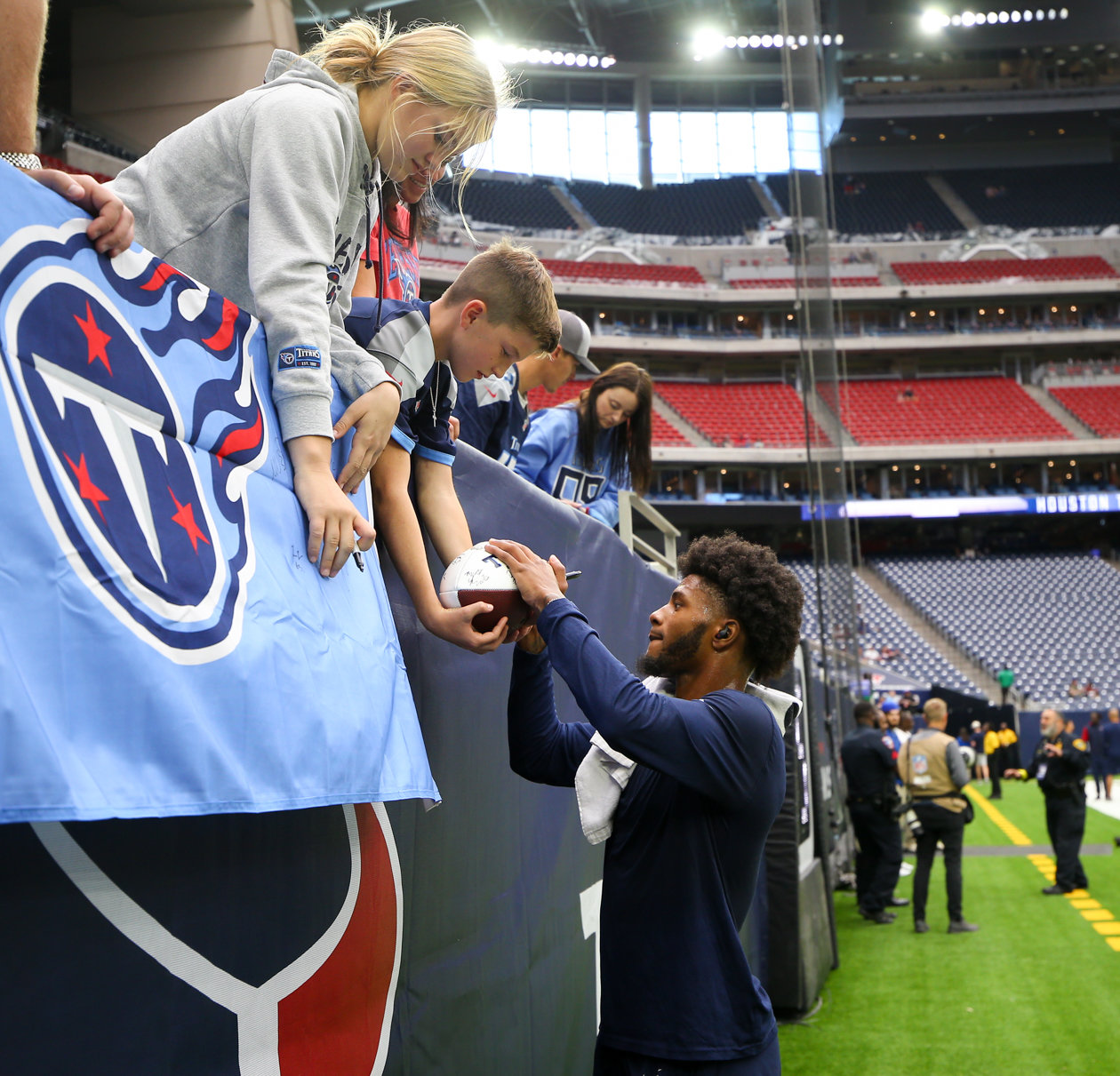Titans cornerback Kristian Fulton (26) signs autographs before the start of an NFL game between the Texans and the Titans on Oct. 30, 2022 in Houston.