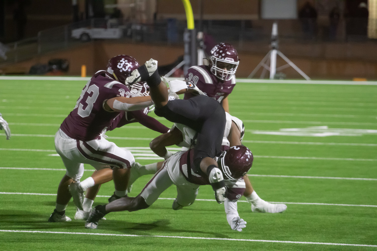 Cinco Ranch's defense wraps up a ballcarrier during Friday's game between Cinco Ranch and George Ranch at Rhodes Stadium.