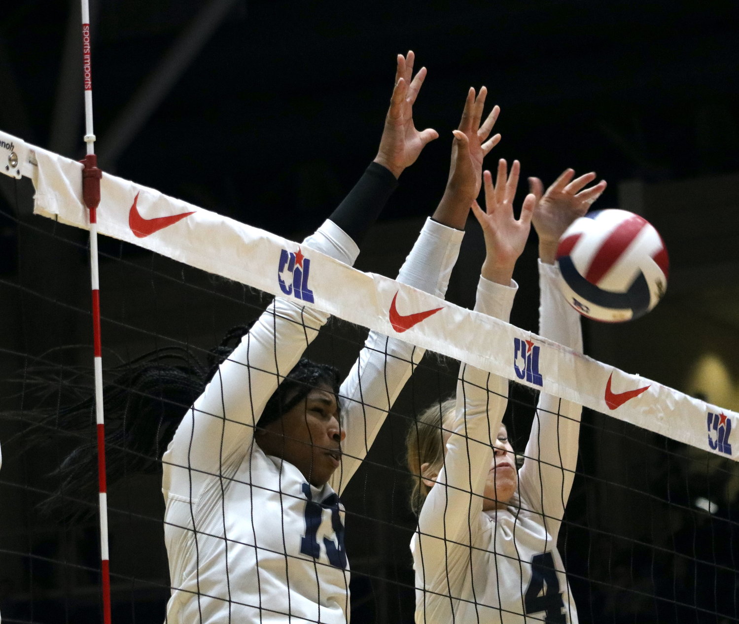 Tendai Titley and Callie Funk block a kill attempt during Friday's Class 6A State Semifinal between Tompkins and Keller on Friday at the Curtis Culwell Center in Garland.