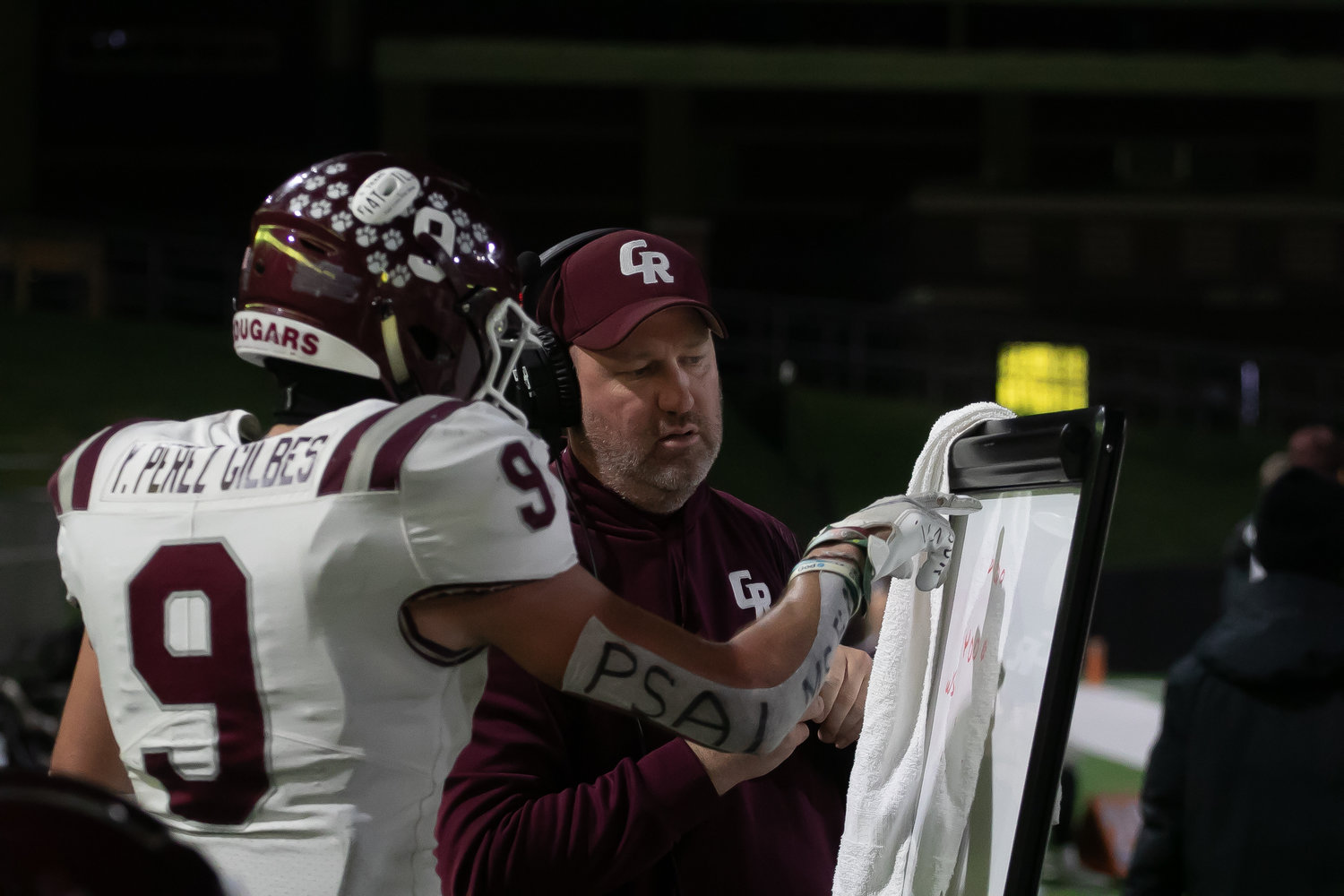 Yetxiel Perez-Gilbes talks with a coach on the sideline during Friday's Class 6A-Division I area round game between Cinco Ranch and Cy-Fair at Pridgeon Stadium.