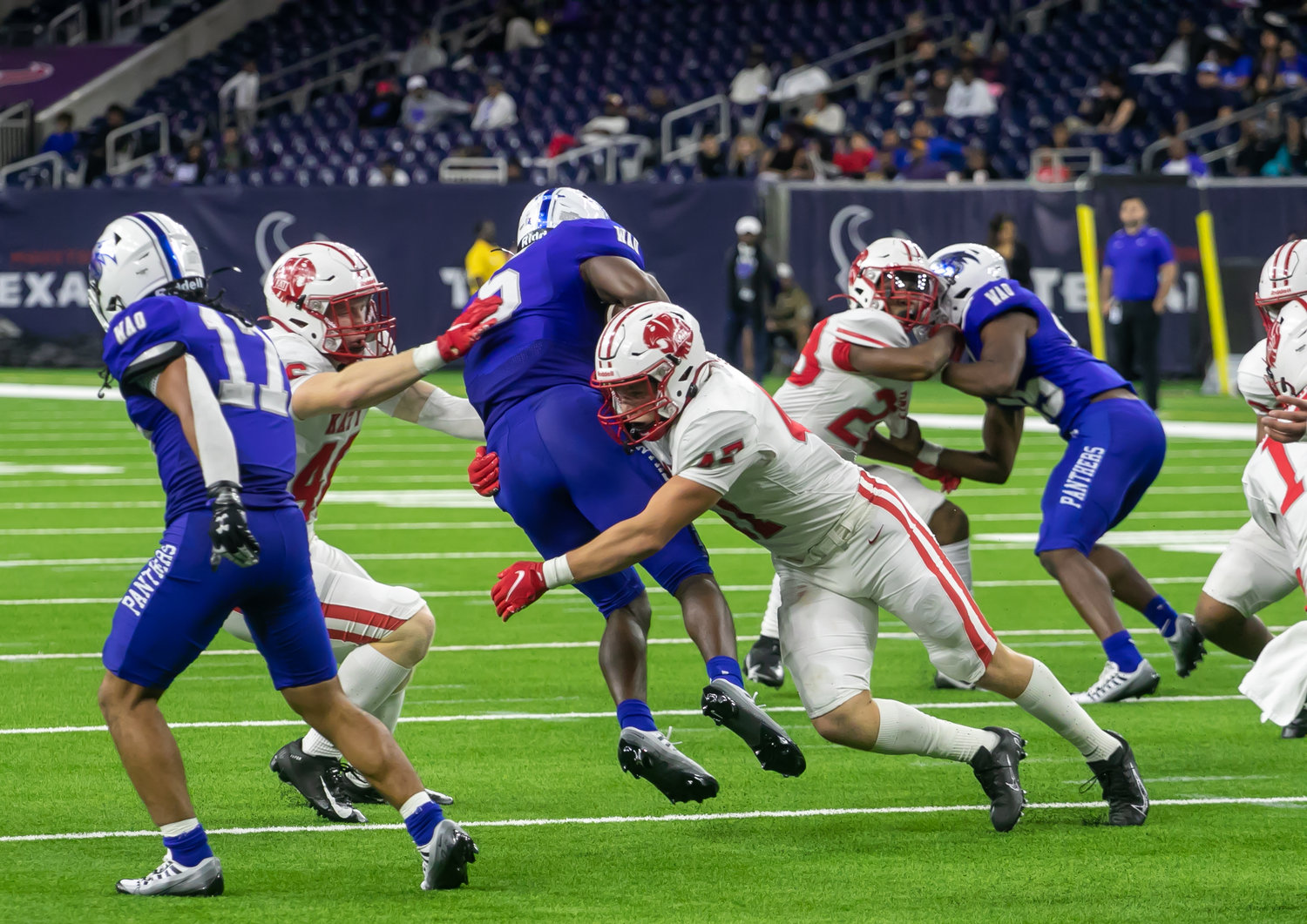 A Katy player wraps up a C.E. King ballcarrier during Friday's Class 6A-Divison II Region III Final between Katy and C.E. King at NRG Stadium.
