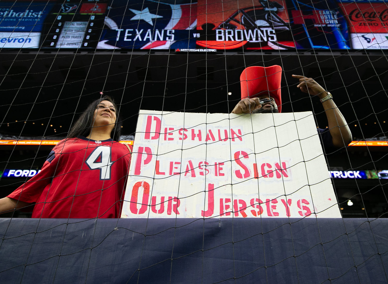 Houston Texans fans await an opportunity for former Texans quarterback Deshaun Watson, now with the Browns, to sign autographs before an NFL game on Dec. 4, 2022, in Houston. The game marks the controversial quarterback’s return to Houston and first game back after an 11-game suspension for allegations of sexual misconduct during his tenure with the Texans.