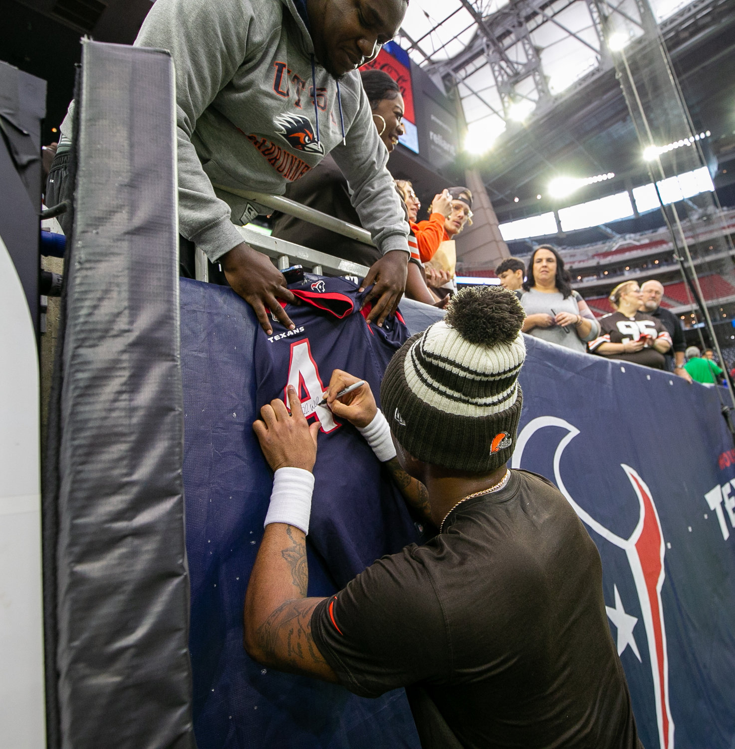 Former Houston Texans and current Cleveland Browns quarterback Deshaun Watson signs autographs before an NFL game on Dec. 4, 2022, in Houston. The game marks the controversial quarterback’s return to Houston and first game back after an 11-game suspension for allegations of sexual misconduct during his tenure with the Texans.