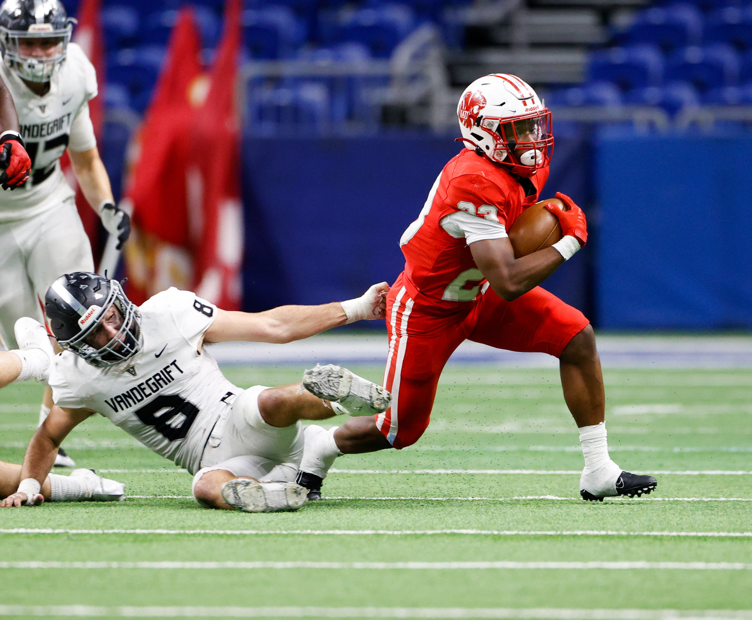Katy running back Seth Davis (23) breaks a tackle attempt by Vandegrift Vipers junior defensive back Alex Foster (8) on a carry during the Class 6A-DII state semifinal football game between Katy and Vandegrift on Dec. 10, 2022 in San Antonio.