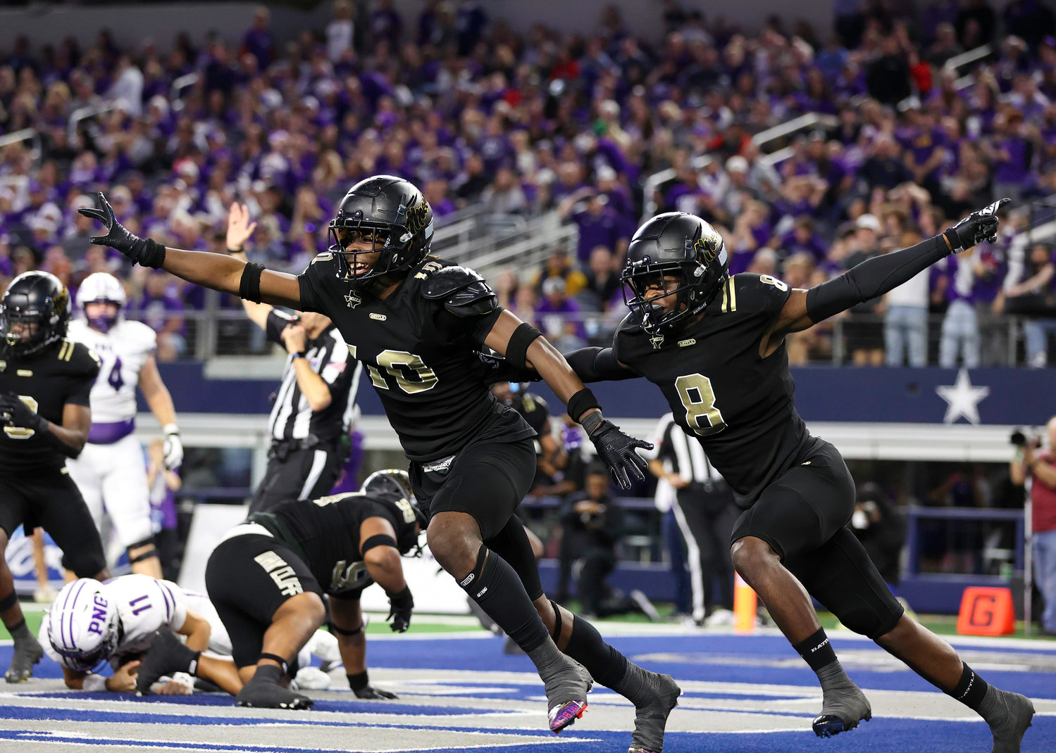 The South Oak Cliff defense celebrates after sacking Port Neches-Groves quarterback Cole Crippen (11) during the Class 5A Division II football state championship game between South Oak Cliff and Port Neches-Groves in Arlington, Texas, on Dec. 16, 2022.