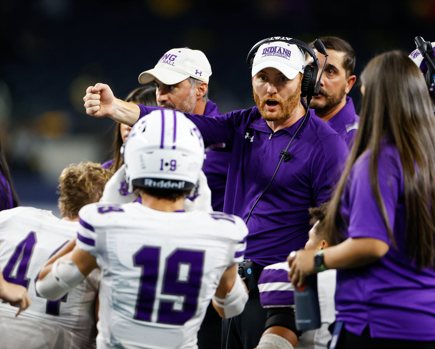 Port Neches-Groves head coach Jeff Joseph (center) talks with his team during a timeout in the Class 5A Division II football state championship game between South Oak Cliff and Port Neches-Groves in Arlington, Texas, on Dec. 16, 2022.